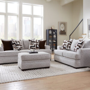 Light gray cognac sofa and loveseat set with plush cushions, oversized accent pillows, and matching ottoman