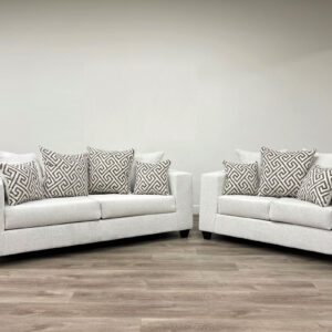 Modern stone-colored sofa and loveseat set with textured fabric and geometric accent pillows