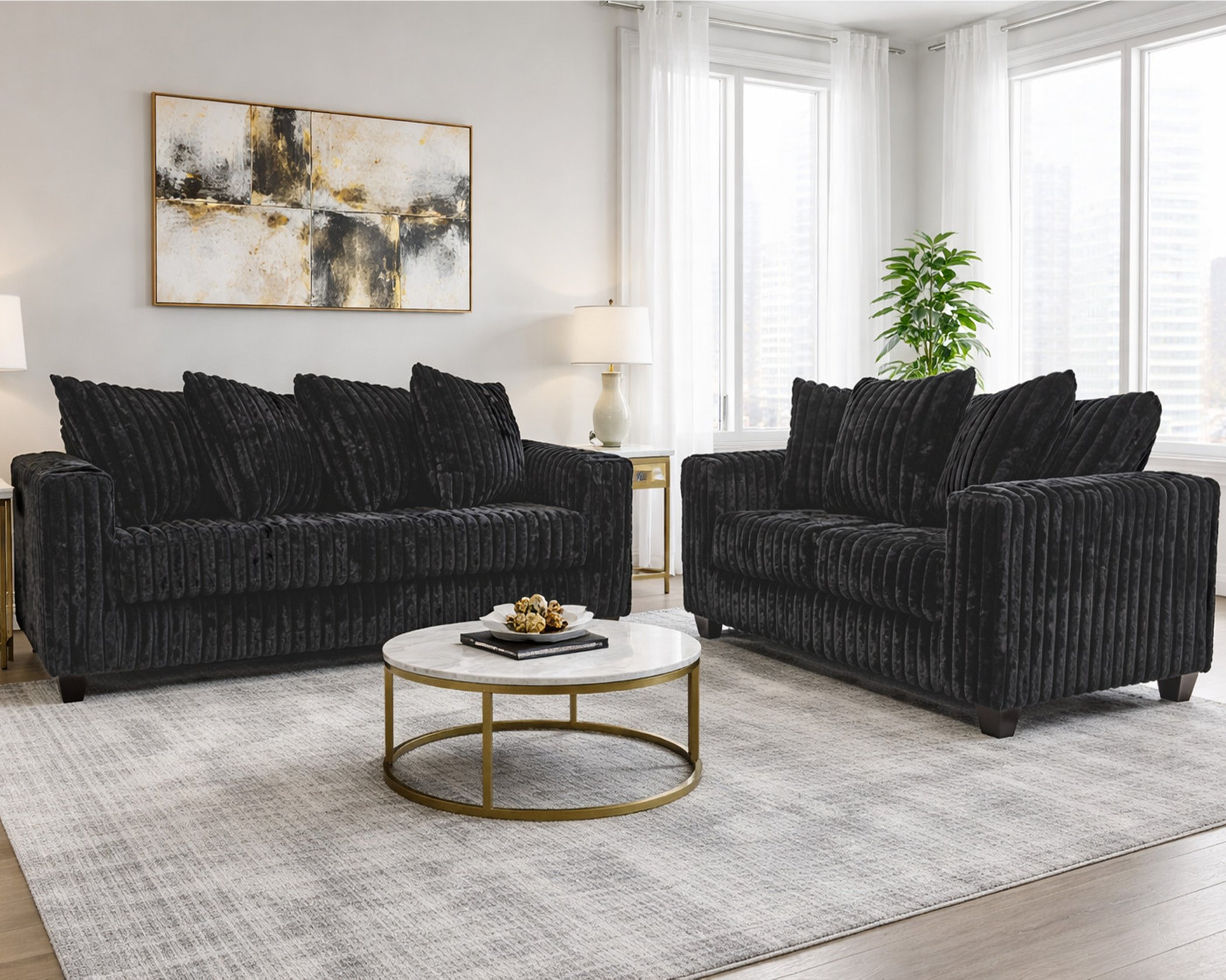 300 Hugo Black sofa and loveseat set with soft black upholstery, channel-tufted design, and modern low-profile silhouette in a bright living room