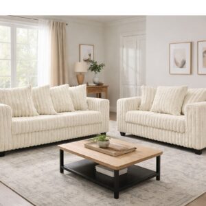 300 Hugo Ivory sofa and loveseat set with soft ivory upholstery, channel-tufted design, and modern low-profile silhouette in a bright living room
