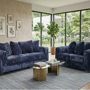 300 Hugo Navy BLue sofa and loveseat set with soft ivory upholstery, channel-tufted design, and modern low-profile silhouette in a bright living room