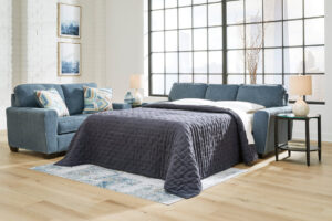 Blue queen sofa sleeper with accent pillows in a modern living room setting