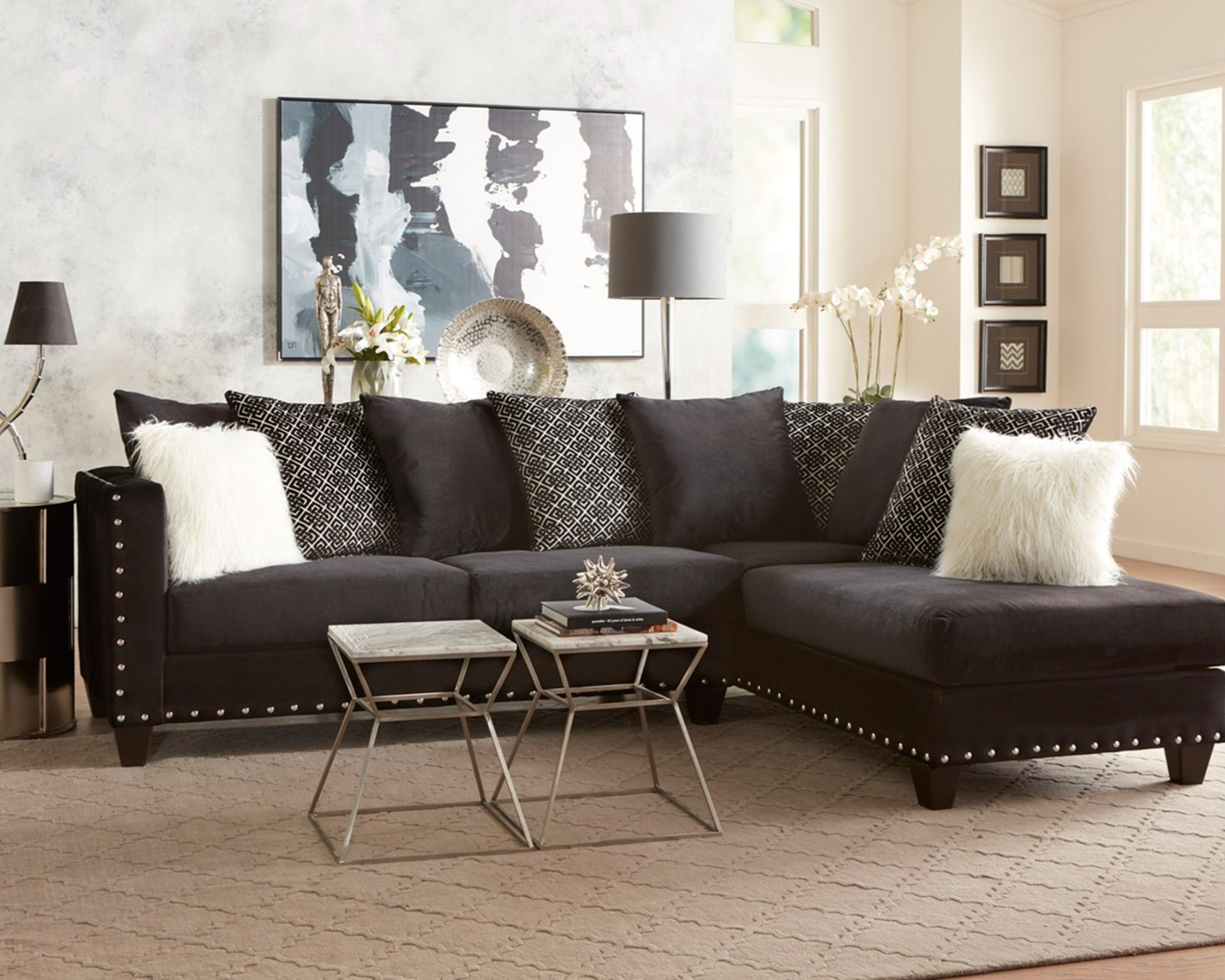 2019 Black Combo sectional with chaise, black upholstery, patterned back cushions, and nailhead trim in a modern living room