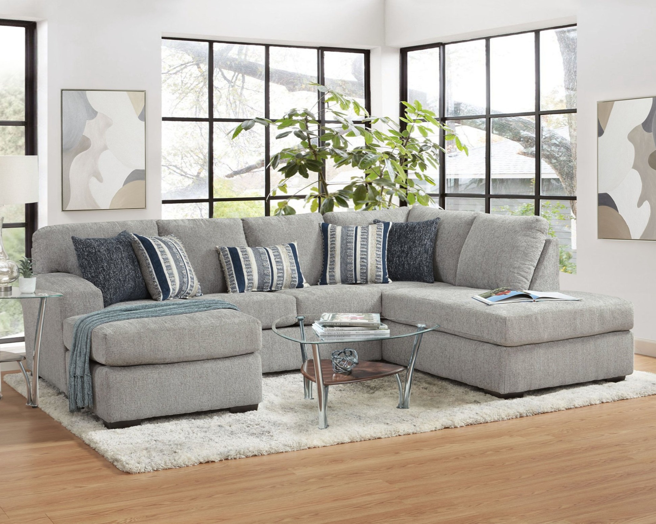 4550 Platinum sectional with chaise, light gray upholstery, plush cushions, and modern L-shaped design in a bright living room