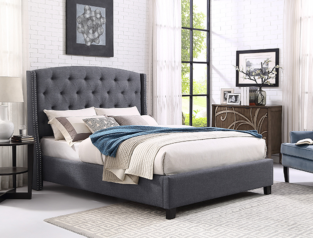 Gray tufted upholstered bed frame with tall button-tufted headboard and nailhead trim in contemporary bedroom