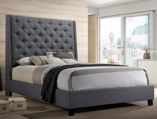 Gray tufted upholstered bed frame with tall button-tufted headboard in modern bedroom