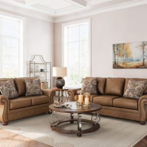 Traditional brown leather sofa and loveseat set with rolled arms, nailhead trim, and decorative accent pillows