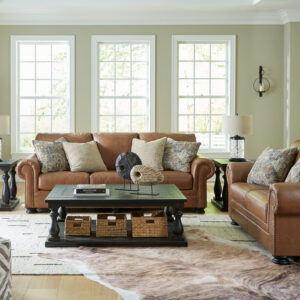 Oversized top grain leather sofa and loveseat set in warm caramel brown with nailhead trim and plush accent pillows