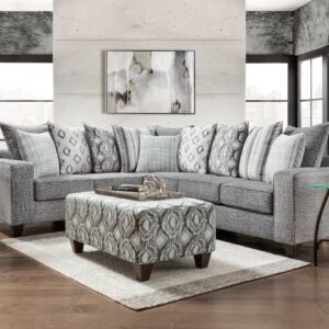 5850 Stonewash Charcoal sectional with chaise, gray stonewashed fabric, plush seating, and decorative accent pillows in a modern living room