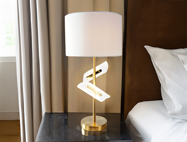 Modern sculptural table lamp with gold base and white shade