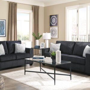 Modern charcoal gray sofa and loveseat set with soft fabric upholstery and decorative accent pillows