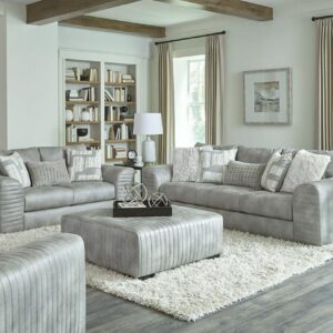 916 Smoke Combo sofa and loveseat set with light gray upholstery, channel-tufted arms, and matching ottoman in a modern living room