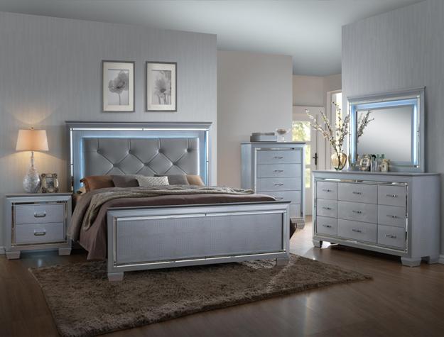 Lillian 7-piece bedroom set with tufted upholstered bed, dresser, mirror, chest, and nightstand in a silver finish with LED headboard lighting and modern glam styling.