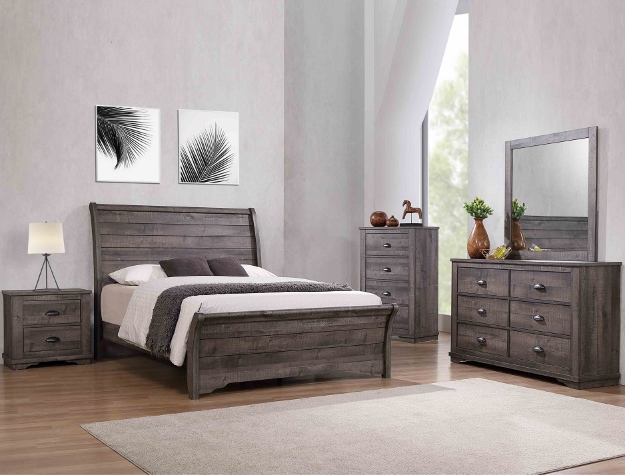 Coralee grey 7-piece bedroom set with rustic sleigh-style bed, dresser, mirror, chest, and nightstand in a weathered gray wood finish with simple hardware.