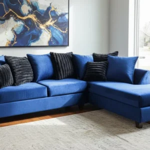 Modern blue sectional sofa with chaise lounge and plush black accent pillows
