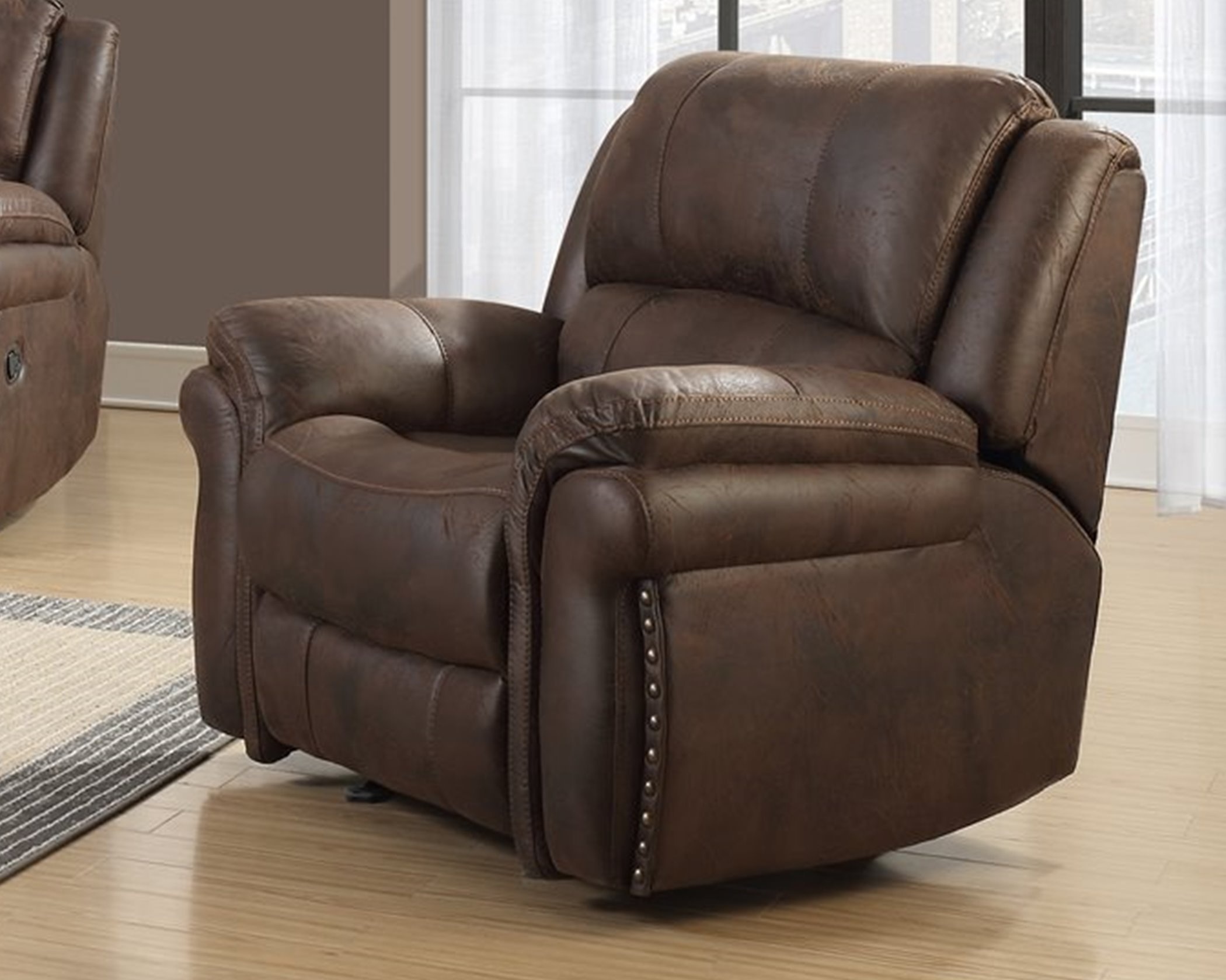 U0903 Chocolate recliner chair with leather-look upholstery, nailhead trim, and manual reclining function