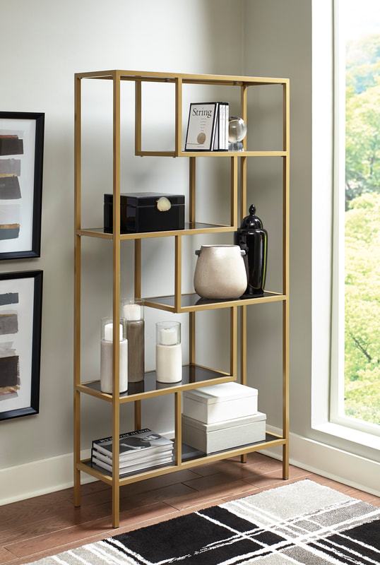 Modern gold metal open bookcase with black shelves and geometric design
