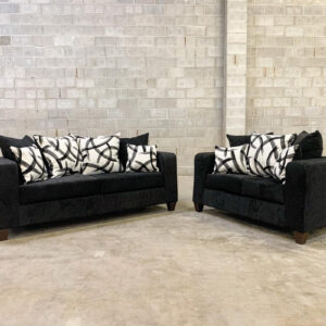Black chenille sofa and loveseat set with modern clean lines and patterned accent pillows